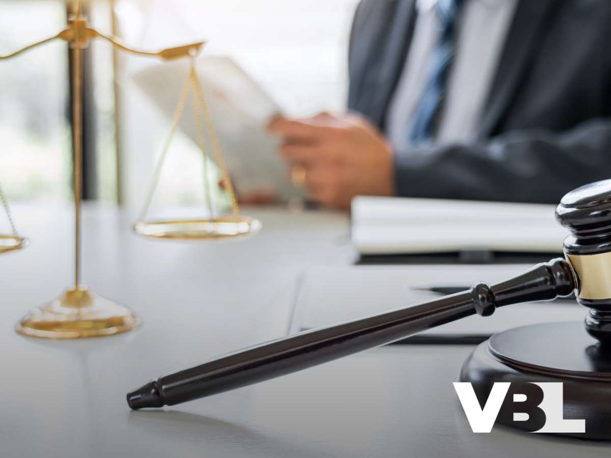 A lawyer reading a document with scales of justice and a gavel on the desk, symbolizing Bankruptcy Filing