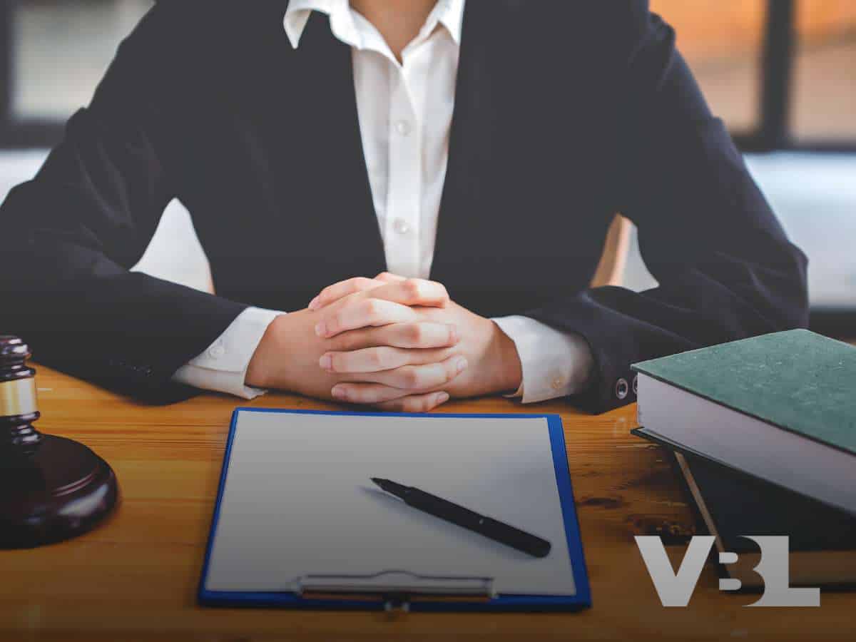 A lawyer in a suit sitting at a desk, ready to discuss bankruptcy options with a client.